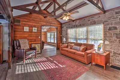 a living room with a couch and a chair at 3 Mi to Slopes! Hot Tub Haven Near Lake Harmony in Lake Harmony