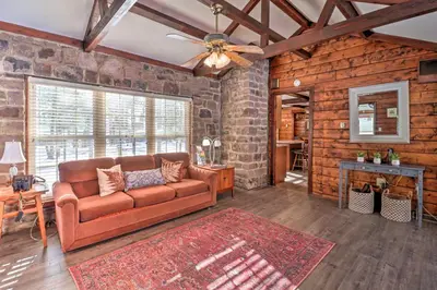 a living room with a couch and a table at 3 Mi to Slopes! Hot Tub Haven Near Lake Harmony in Lake Harmony