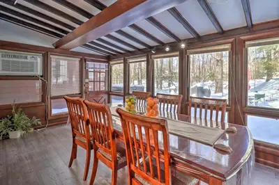 a dining room with a wooden table and chairs at 3 Mi to Slopes! Hot Tub Haven Near Lake Harmony in Lake Harmony