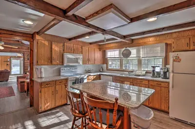 a kitchen with wooden cabinets and a counter top at 3 Mi to Slopes! Hot Tub Haven Near Lake Harmony in Lake Harmony