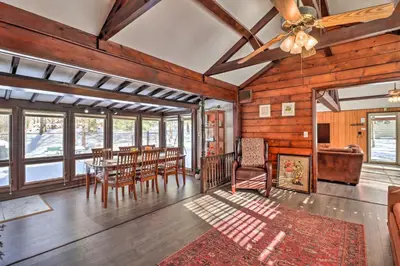 a dining room with a ceiling fan and a table and chairs at 3 Mi to Slopes! Hot Tub Haven Near Lake Harmony in Lake Harmony
