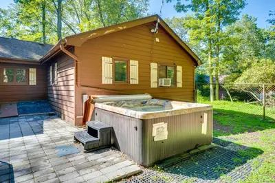 a house with a hot tub in front of it at 3 Mi to Slopes! Hot Tub Haven Near Lake Harmony in Lake Harmony