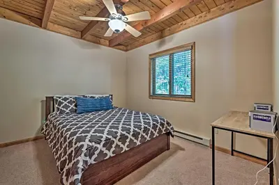 a bedroom with a bed and a ceiling fan at Mountain Cabin with Deck Near Year-Round Recreation! in Lake Ariel