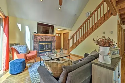 a living room with a couch and a fireplace at Mountain Cabin with Deck Near Year-Round Recreation! in Lake Ariel