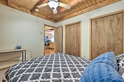 a bedroom with a bed and a ceiling fan at Mountain Cabin with Deck Near Year-Round Recreation! in Lake Ariel