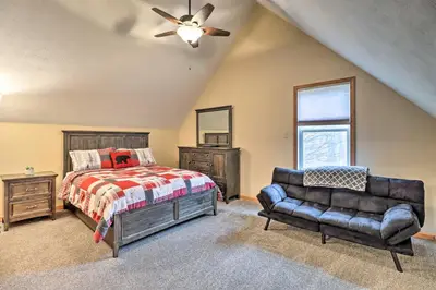 a bedroom with a bed and a couch at Near Lake and Hiking Pocono Home with Hot Tub in Albrightsville