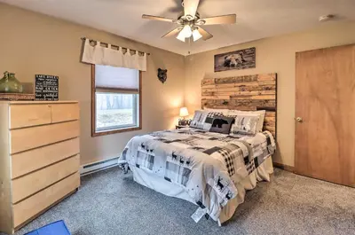 a bedroom with a bed and a ceiling fan at Near Lake and Hiking Pocono Home with Hot Tub in Albrightsville