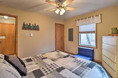 a bedroom with a bed and a ceiling fan at Near Lake and Hiking Pocono Home with Hot Tub in Albrightsville