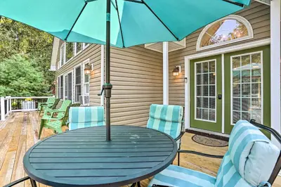 a blue table with chairs and an umbrella on a patio at Near Lake and Hiking Pocono Home with Hot Tub in Albrightsville