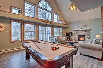 a living room with a pool table and a fireplace at Near Lake and Hiking Pocono Home with Hot Tub in Albrightsville