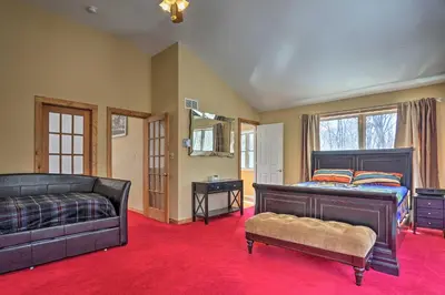 a bedroom with a bed and a couch at Cozy Retreat with Deck and Hot Tub, 20 mins to Kalahari in Tobyhanna