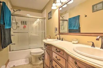 a bathroom with a sink and a shower and a toilet at Cozy Retreat with Deck and Hot Tub, 20 mins to Kalahari in Tobyhanna