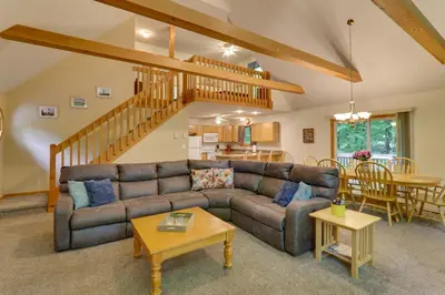 a living room with a couch and a table at Deck and Resort Amenities Arrowhead Lake Home! in Pocono Lake