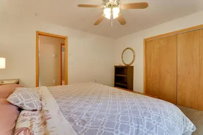 a bedroom with a bed and a ceiling fan at Deck and Resort Amenities Arrowhead Lake Home! in Pocono Lake