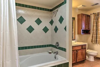 a bathroom with a bath tub and a toilet at Mountain Creek Resort Home - Hot Tub and Pool Access in Vernon Township