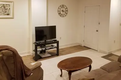 a living room with a couch and a tv at Pocono Mountain Home with 3 Community Lakes! in Gouldsboro