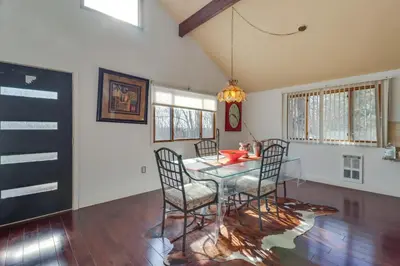 a dining room with a glass table and chairs at Cozy Pennsylvania Home with Pool Table and Pool Access in Effort