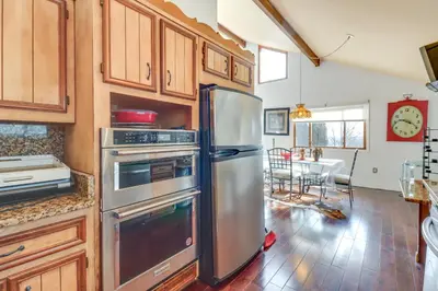 a kitchen with a stainless steel refrigerator and a table at Cozy Pennsylvania Home with Pool Table and Pool Access in Effort