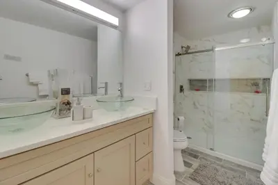 a bathroom with a glass sink and a shower at Cozy Pennsylvania Home with Pool Table and Pool Access in Effort