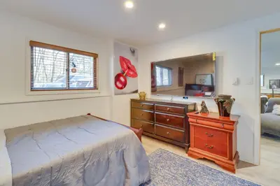 a bedroom with a bed and a dresser and a mirror at Cozy Pennsylvania Home with Pool Table and Pool Access in Effort