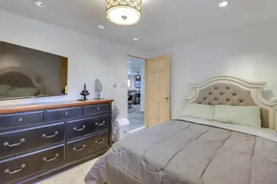 a bedroom with a bed and a dresser with a television at Cozy Pennsylvania Home with Pool Table and Pool Access in Effort