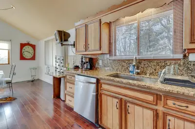 a kitchen with wooden cabinets and a sink at Cozy Pennsylvania Home with Pool Table and Pool Access in Effort