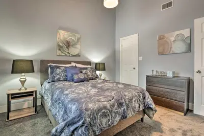 a bedroom with a bed and a dresser and a night stand at Near Mt Airy Casino Mount Pocono Condo with Balcony in Mount Pocono