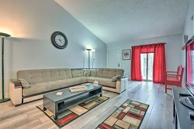 a living room with a couch and a table at Near Mt Airy Casino Mount Pocono Condo with Balcony in Mount Pocono