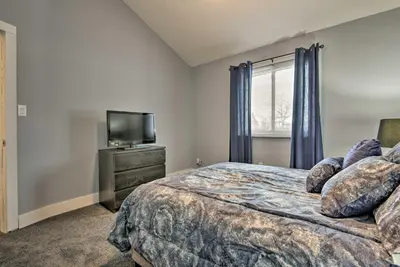 a bedroom with a bed and a flat screen tv at Near Mt Airy Casino Mount Pocono Condo with Balcony in Mount Pocono