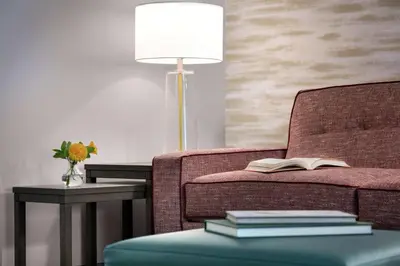 a living room with a couch with a lamp and a book at Home2 Suites By Hilton Easton in Easton