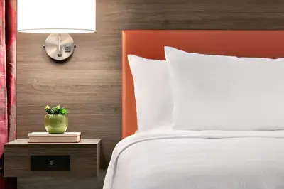 a bedroom with a bed and a table with a lamp at Home2 Suites By Hilton Easton in Easton