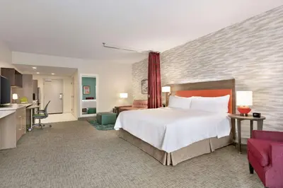 a hotel room with a large bed and a kitchen at Home2 Suites By Hilton Easton in Easton