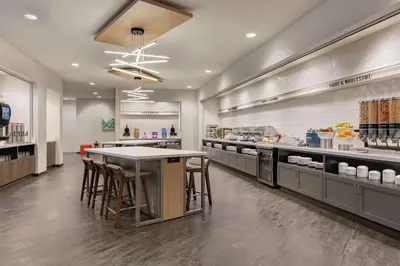 a large kitchen with a table and stools at Home2 Suites By Hilton Easton in Easton