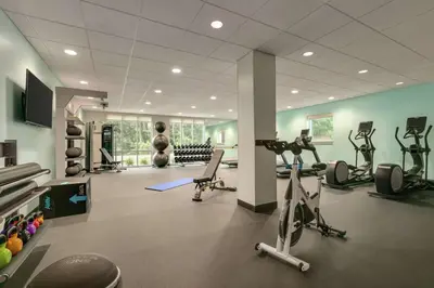 a gym with several treadmills and exercise bikes in it at Home2 Suites By Hilton Easton in Easton