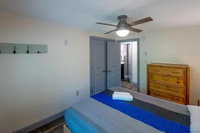 a bedroom with a blue bed and a ceiling fan at 2 Mi to Big Boulder Mtn Family Ski Gem on 1 Acre! in Lake Harmony