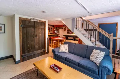 a living room with a blue couch and a table at 2 Mi to Big Boulder Mtn Family Ski Gem on 1 Acre! in Lake Harmony