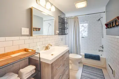 a bathroom with a sink and a toilet and a mirror at By Mtn Creek Resort The Point on Highland Lake in Highland Lakes