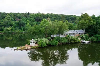 an island in the middle of a lake with a house at By Mtn Creek Resort The Point on Highland Lake in Highland Lakes