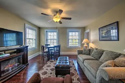 a living room with a couch and a ceiling fan at Walk to Shops, Dining and City Park Reading Apt in Reading