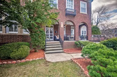 a brick house with a staircase leading to the front door at Walk to Shops, Dining and City Park Reading Apt in Reading