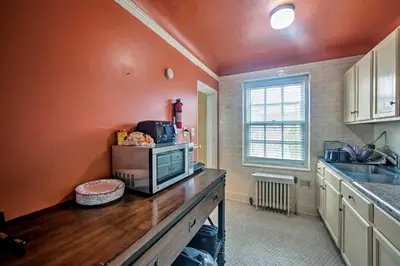 a kitchen with a counter with a microwave on it at Walk to Shops, Dining and City Park Reading Apt in Reading