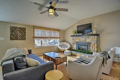 a living room with a couch and a fireplace at Waterfront Pocono Lake Home with Private Dock! in Pocono Lake