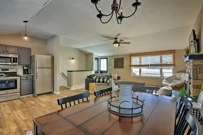a kitchen and living room with a table and a dining room at Waterfront Pocono Lake Home with Private Dock! in Pocono Lake