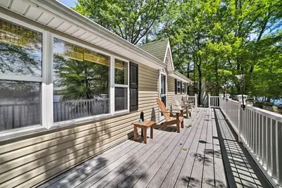 a porch of a house with two benches on it at Waterfront Pocono Lake Home with Private Dock! in Pocono Lake