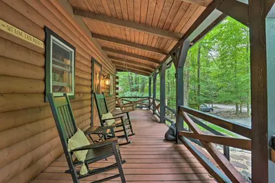 a porch of a cabin with chairs on it at Pocono Log Cabin Fireplace, Fire Pits and Amenities in Pocono Lake