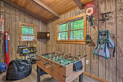 a room with a foosball table in a wooden wall at Pocono Log Cabin Fireplace, Fire Pits and Amenities in Pocono Lake