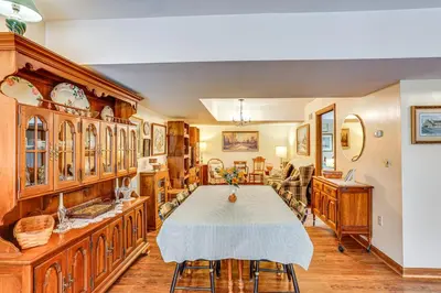 a dining room with a table and some wooden cabinets at Charming Apartment with Yard and Beautiful Gardens! in Manheim