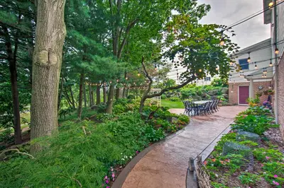 a garden with benches and flowers and trees at Charming Apartment with Yard and Beautiful Gardens! in Manheim