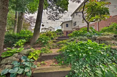 a garden with stone steps in front of a house at Charming Apartment with Yard and Beautiful Gardens! in Manheim