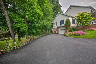 a driveway in front of a house with flowers at Charming Apartment with Yard and Beautiful Gardens! in Manheim